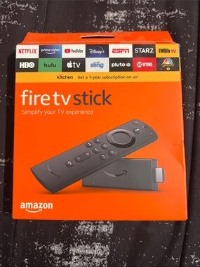 Brand New Amazon Fire TV Stick with Black Remote on Orange Box